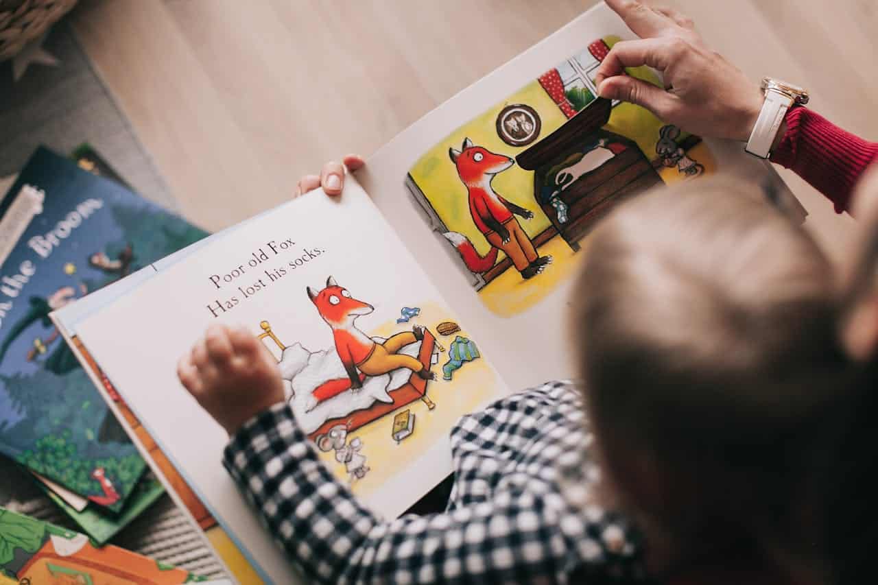 A child reading a book.
Photo by Lina Kivaka: https://www.pexels.com/photo/person-reading-a-book-1741230/