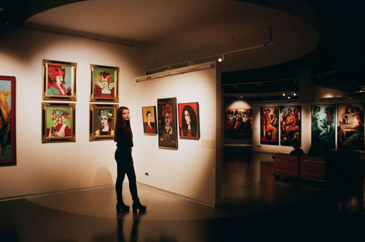 Photo by Darya Sannikova: https://www.pexels.com/photo/woman-wearing-black-top-standing-near-paintings-1671016/